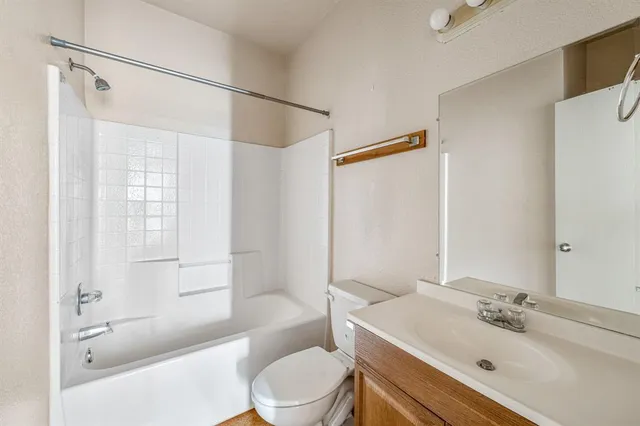 a bathroom with a sink mirror toilet and bathtub