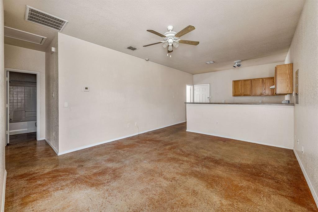 255 Baughman Hill Road Azle, TX 76020 - Photo 25 of 40 a view of a livingroom with a ceiling fan and wooden floor