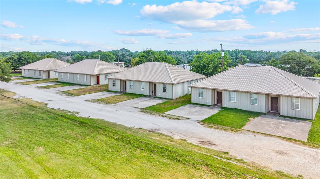 255 Baughman Hill Road Azle, TX 76020 - Photo 3 of 40 a view of a big house with a big yard and large trees