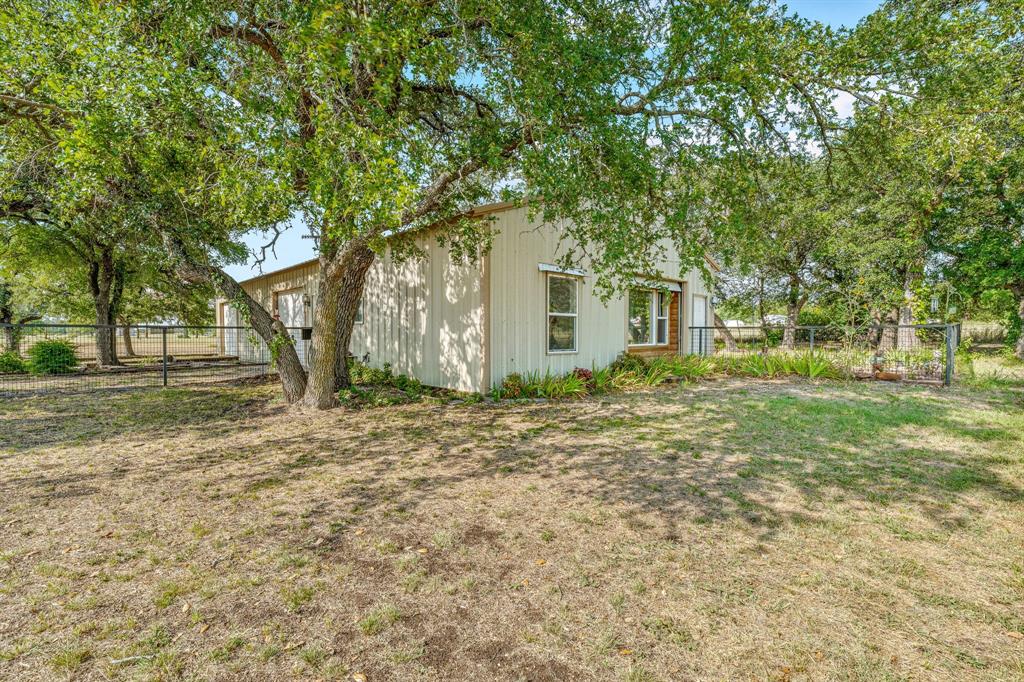 255 Baughman Hill Road Azle, TX 76020 - Photo 7 of 40 a house with trees in front of it