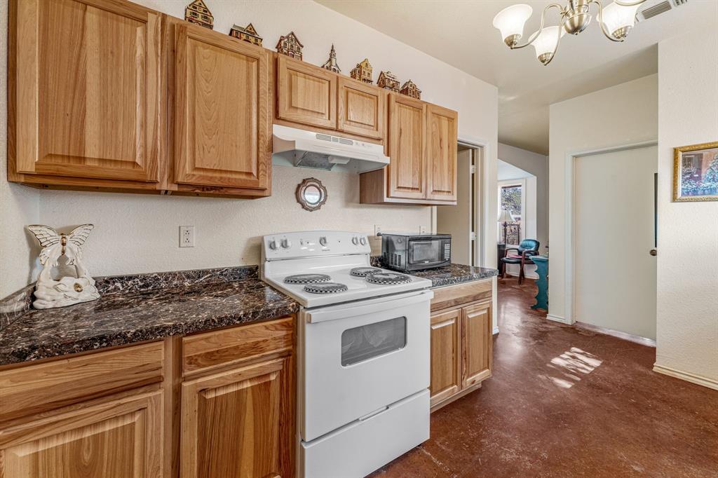 255 Baughman Hill Road Azle, TX 76020 - Photo 9 of 40 a kitchen with stainless steel appliances granite countertop a stove a sink and a microwave