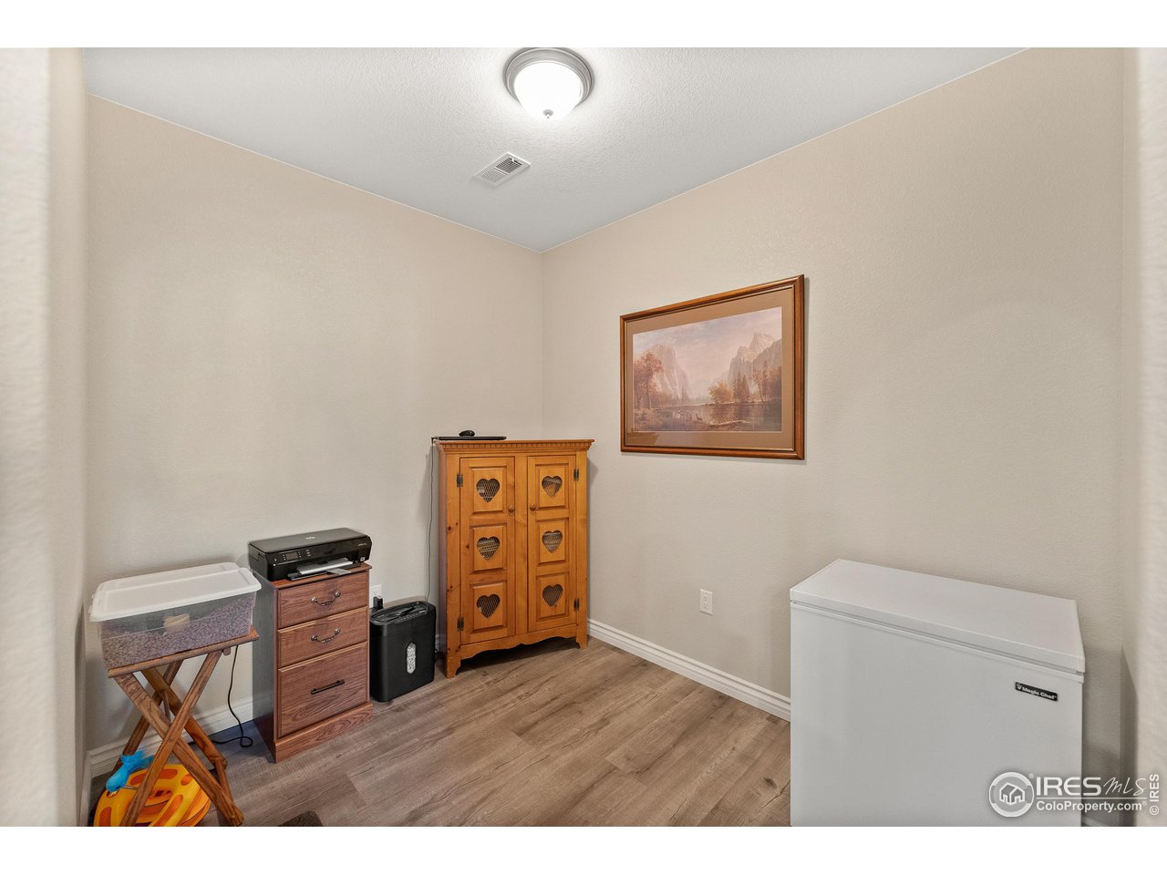 4672 West 20th Road, Unit 723 Greeley, CO 80634 - Photo 11 of 27 a living room with furniture and a wooden floor