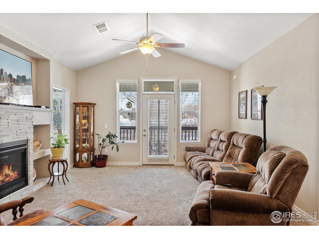 4672 West 20th Road, Unit 723 Greeley, CO 80634 - Photo 15 of 27 a living room with furniture and a fireplace