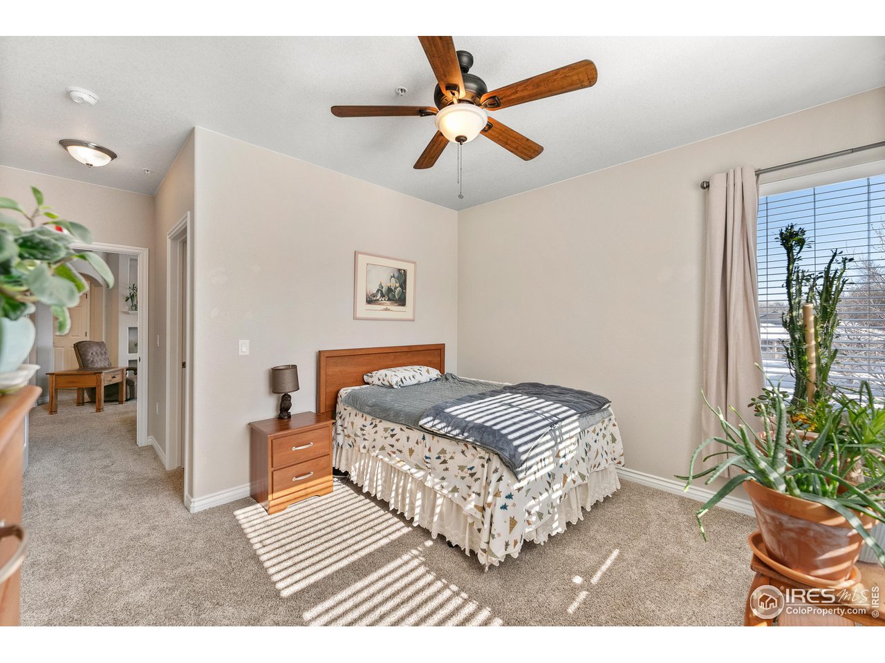 4672 West 20th Road, Unit 723 Greeley, CO 80634 - Photo 19 of 27 a bedroom with a bed and a view of bathroom