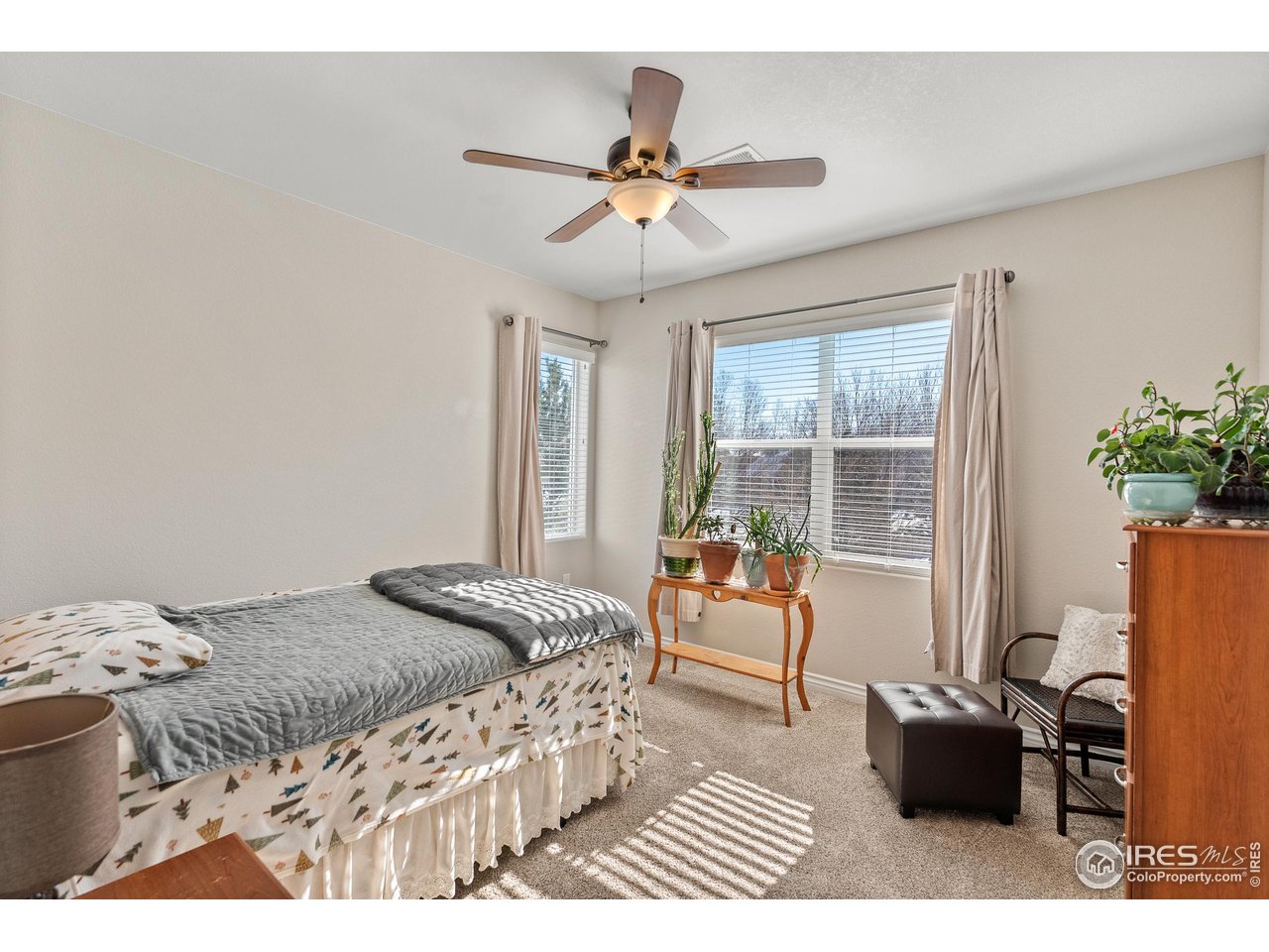 4672 West 20th Road, Unit 723 Greeley, CO 80634 - Photo 22 of 27 a bedroom with a bed and glass door