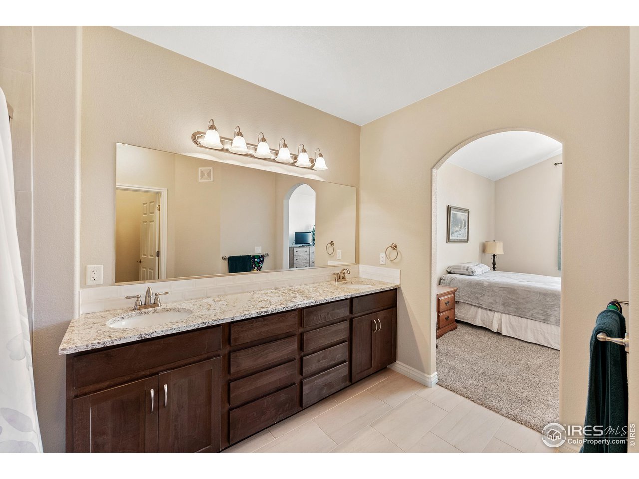 4672 West 20th Road, Unit 723 Greeley, CO 80634 - Photo 24 of 27 a spacious bathroom with a granite countertop double vanity sink a mirror and bathtub