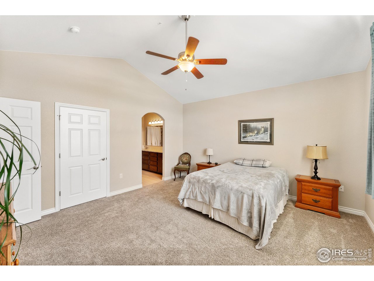 4672 West 20th Road, Unit 723 Greeley, CO 80634 - Photo 25 of 27 a bedroom with a bed and a chandelier