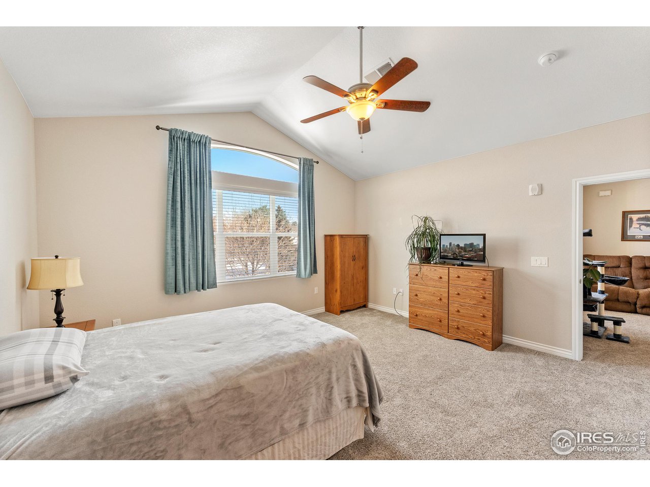 4672 West 20th Road, Unit 723 Greeley, CO 80634 - Photo 26 of 27 a bedroom with a bed and a chandelier