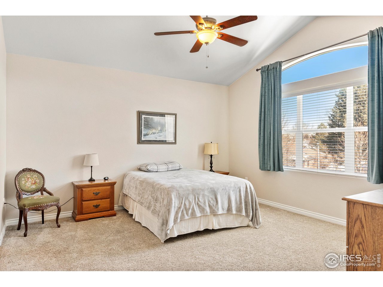 4672 West 20th Road, Unit 723 Greeley, CO 80634 - Photo 27 of 27 a bedroom with a bed a chandelier and a window