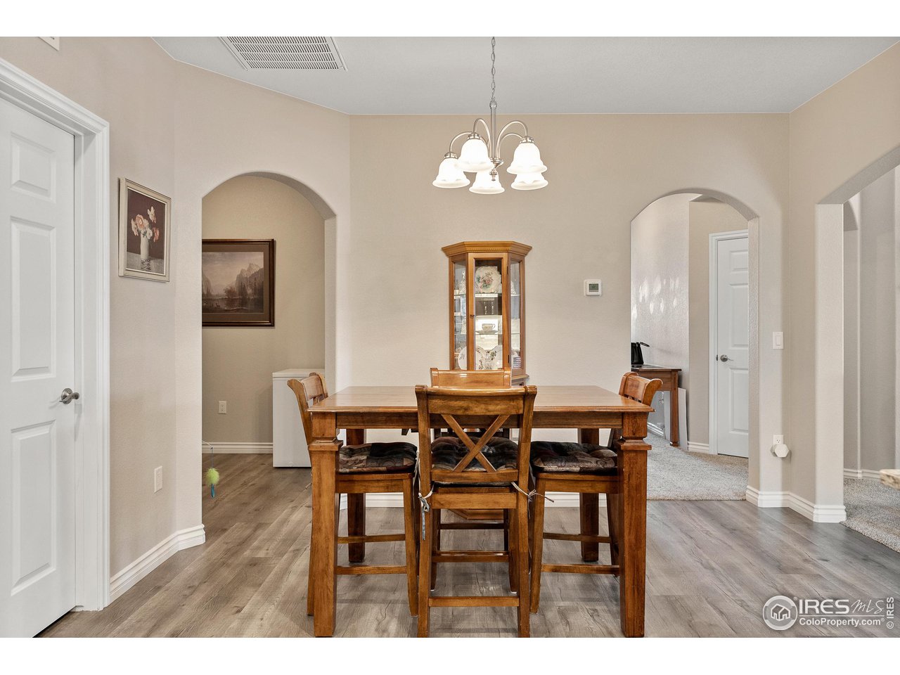 4672 West 20th Road, Unit 723 Greeley, CO 80634 - Photo 8 of 27 a view of a dining room with furniture wooden floor and chandelier