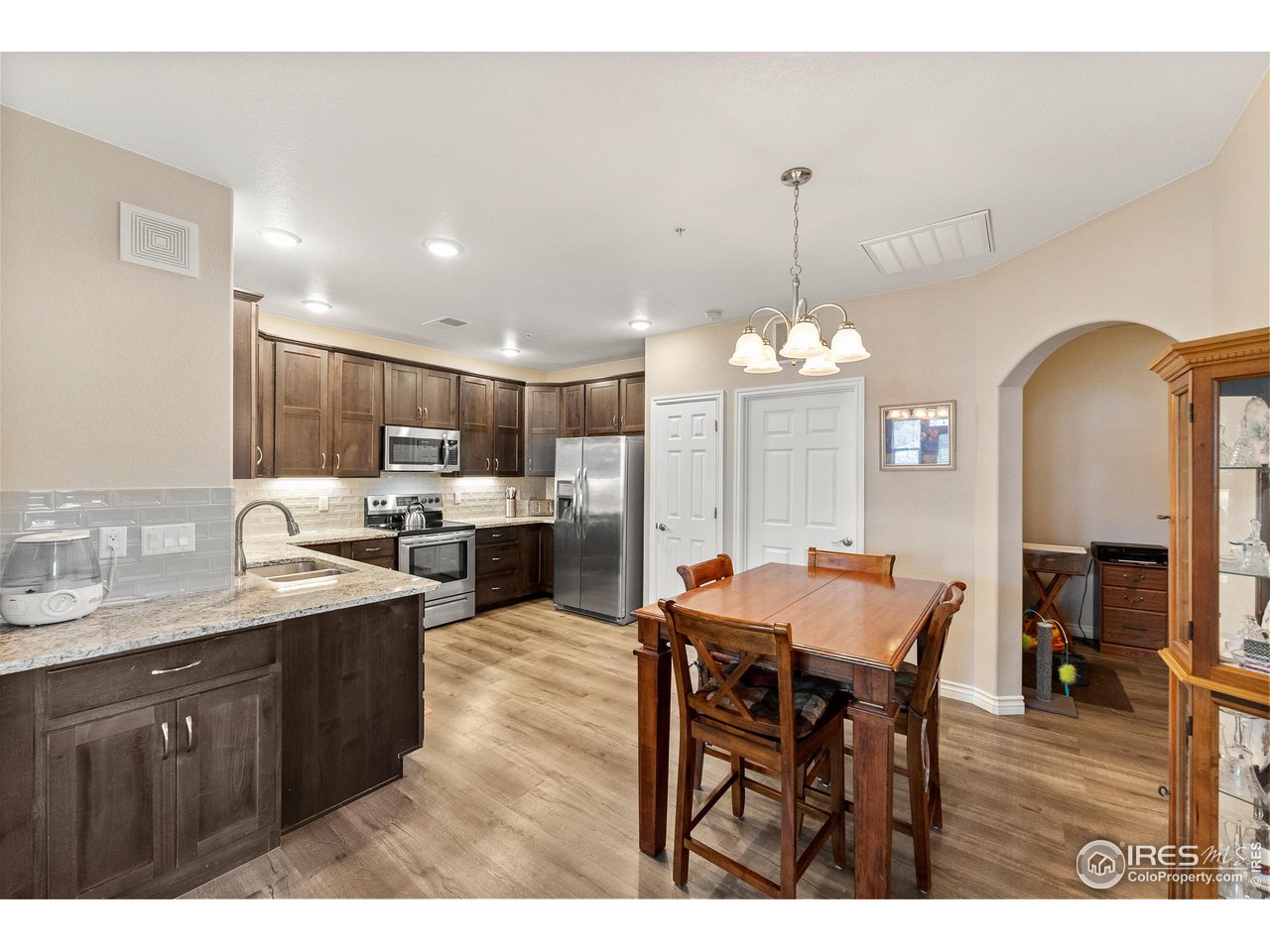 4672 West 20th Road, Unit 723 Greeley, CO 80634 - Photo 10 of 27 a large kitchen with a table and chairs