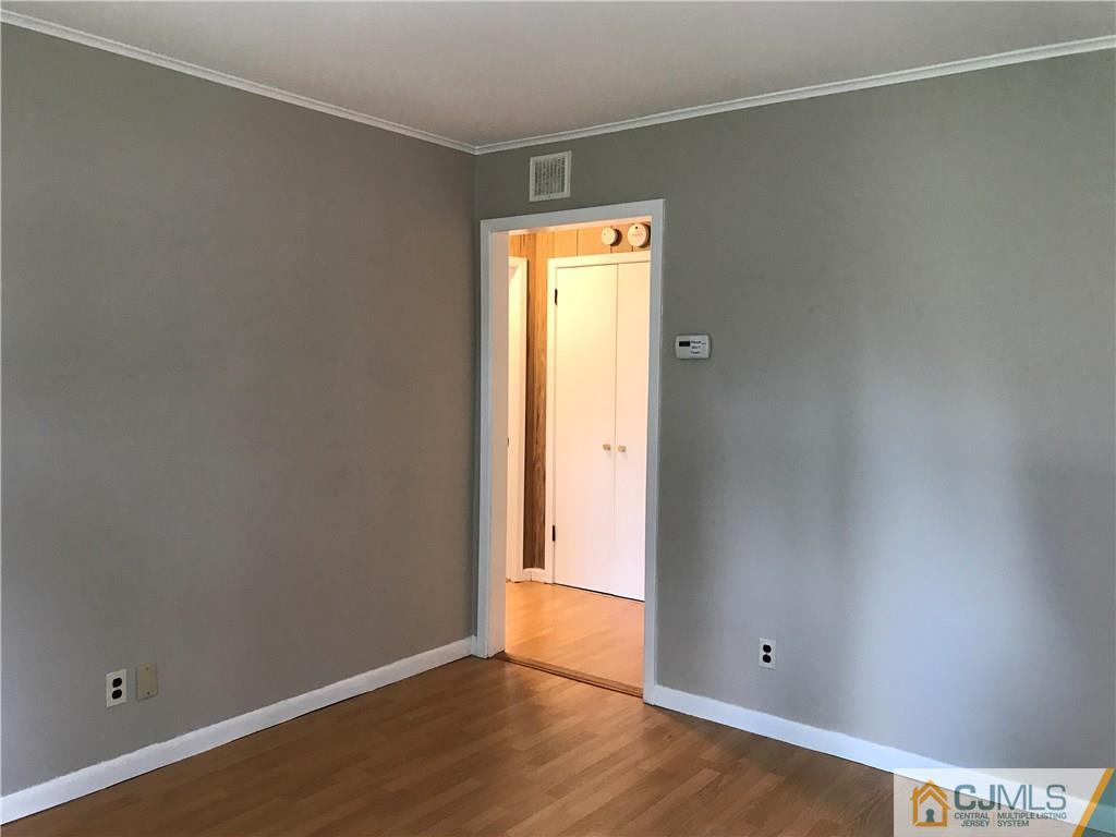 46 Rosewood Road Edison, NJ 08817 - Photo 3 of 25 a view of an empty room with wooden floor and a window