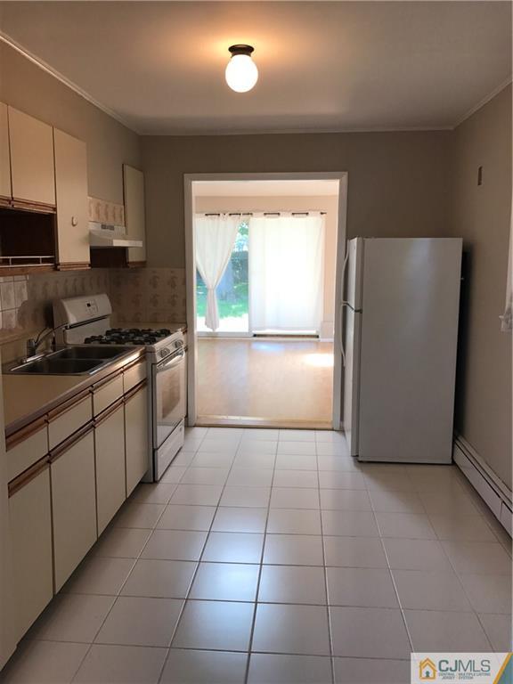 46 Rosewood Road Edison, NJ 08817 - Photo 22 of 25 a kitchen with a refrigerator a stove a microwave and cabinets