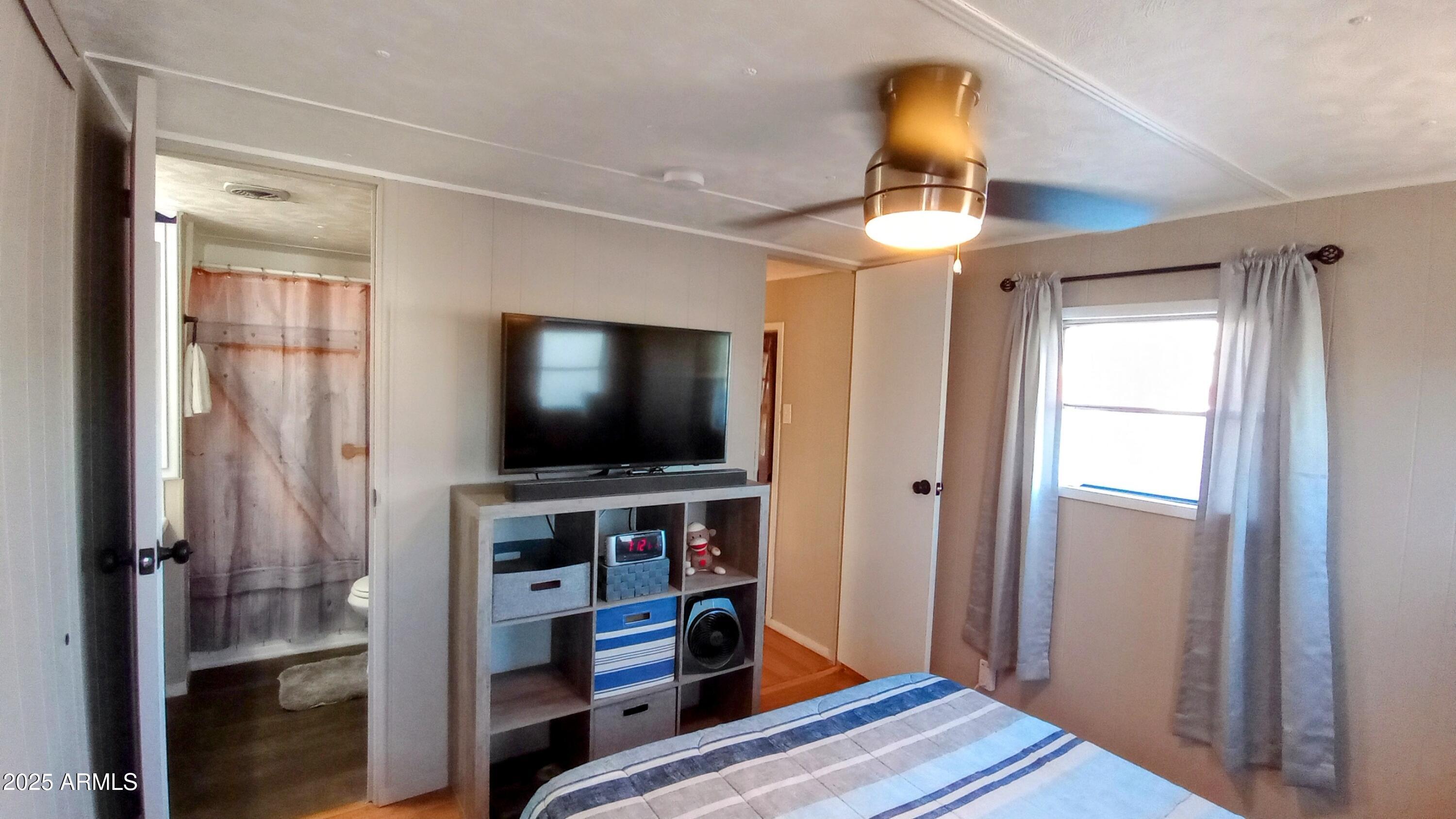 269 North Winchester Road, Unit 2 Apache Junction, AZ 85119 - Photo 14 of 36 a room with wooden floor and a window