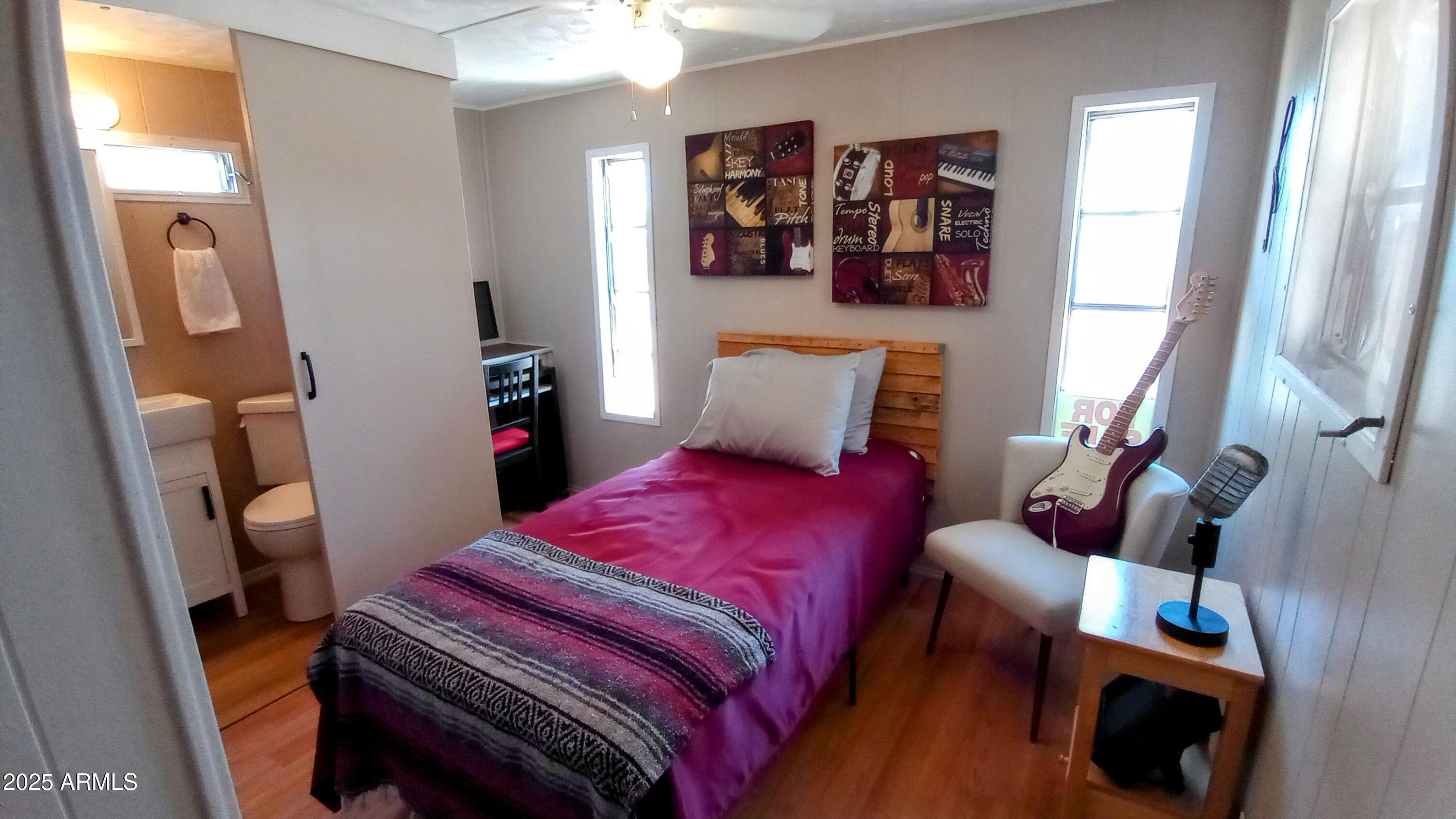 269 North Winchester Road, Unit 2 Apache Junction, AZ 85119 - Photo 18 of 36 a bedroom with a bed and wooden floor