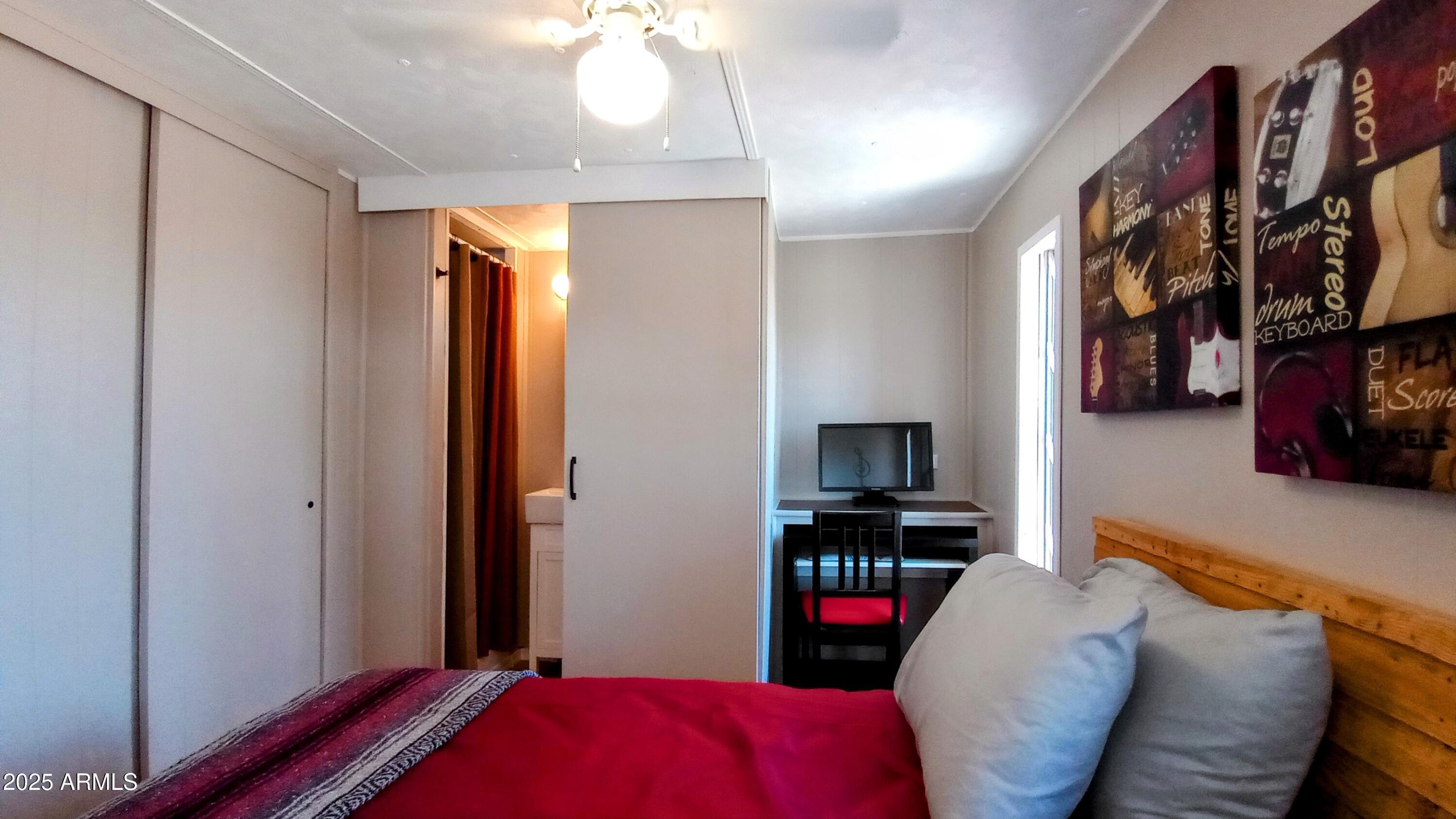 269 North Winchester Road, Unit 2 Apache Junction, AZ 85119 - Photo 19 of 36 a bedroom with a bed and a television