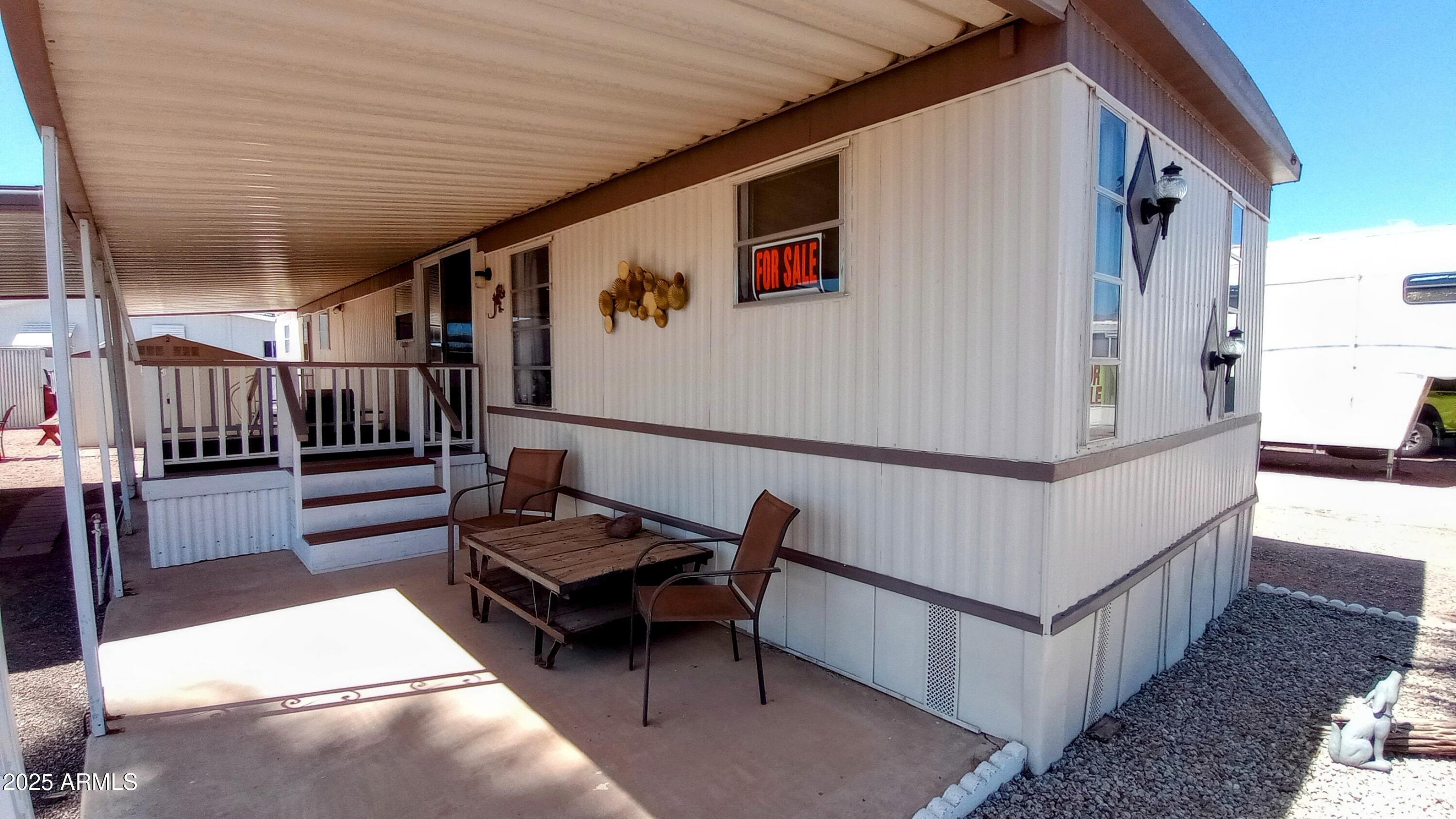 269 North Winchester Road, Unit 2 Apache Junction, AZ 85119 - Photo 3 of 36 a view of a porch with furniture and a gate