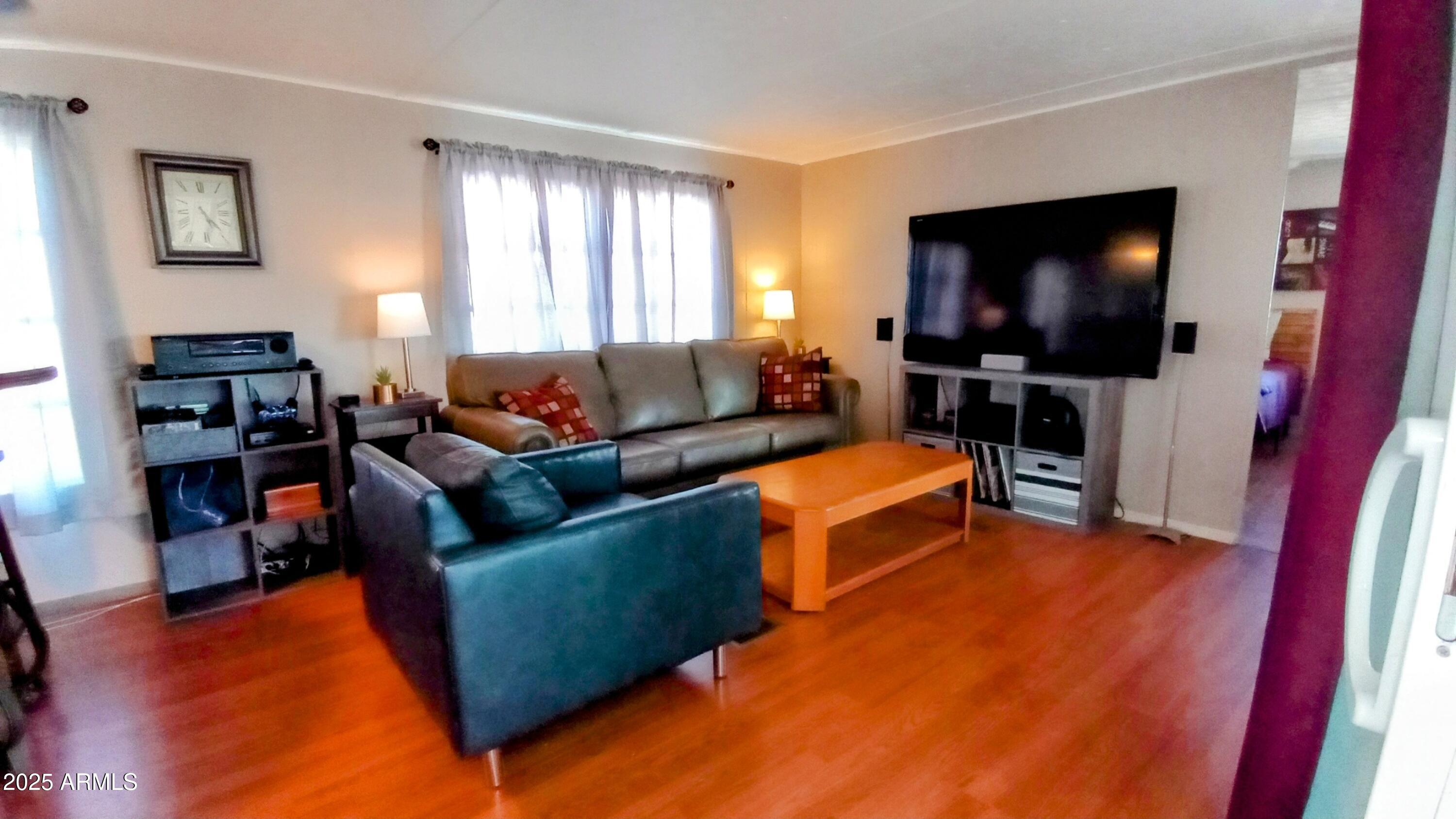 269 North Winchester Road, Unit 2 Apache Junction, AZ 85119 - Photo 6 of 36 a living room with furniture and a flat screen tv