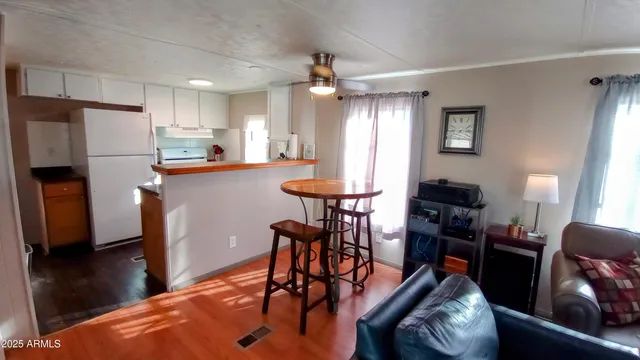 a kitchen with stainless steel appliances granite countertop a sink a stove and a wooden floors