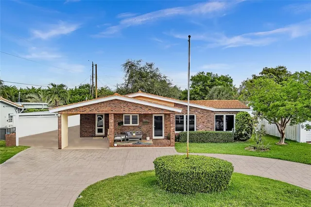 a patio with a table and chairs under an umbrella