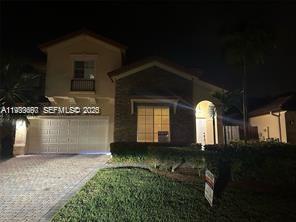 8836 Southwest 221st Terrace Miami, FL 33190 - Photo 2 of 4 a front view of a house with a yard