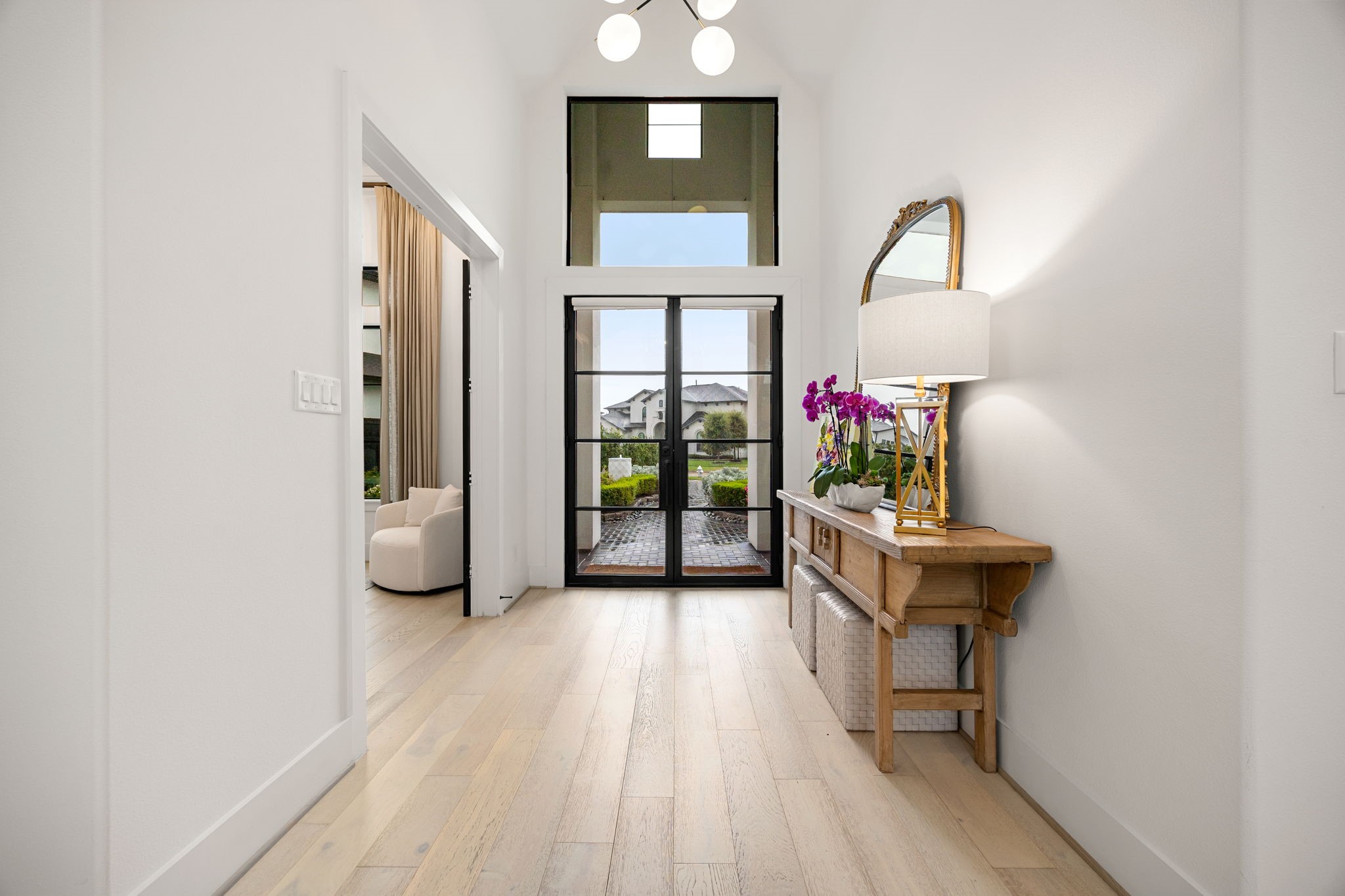 27903 Indigo Ridge Drive Fulshear, TX 77441 - Photo 5 of 50 Elegant entryway featuring wide-plank flooring, soaring ceilings, and seamless flow into the main living areas.
