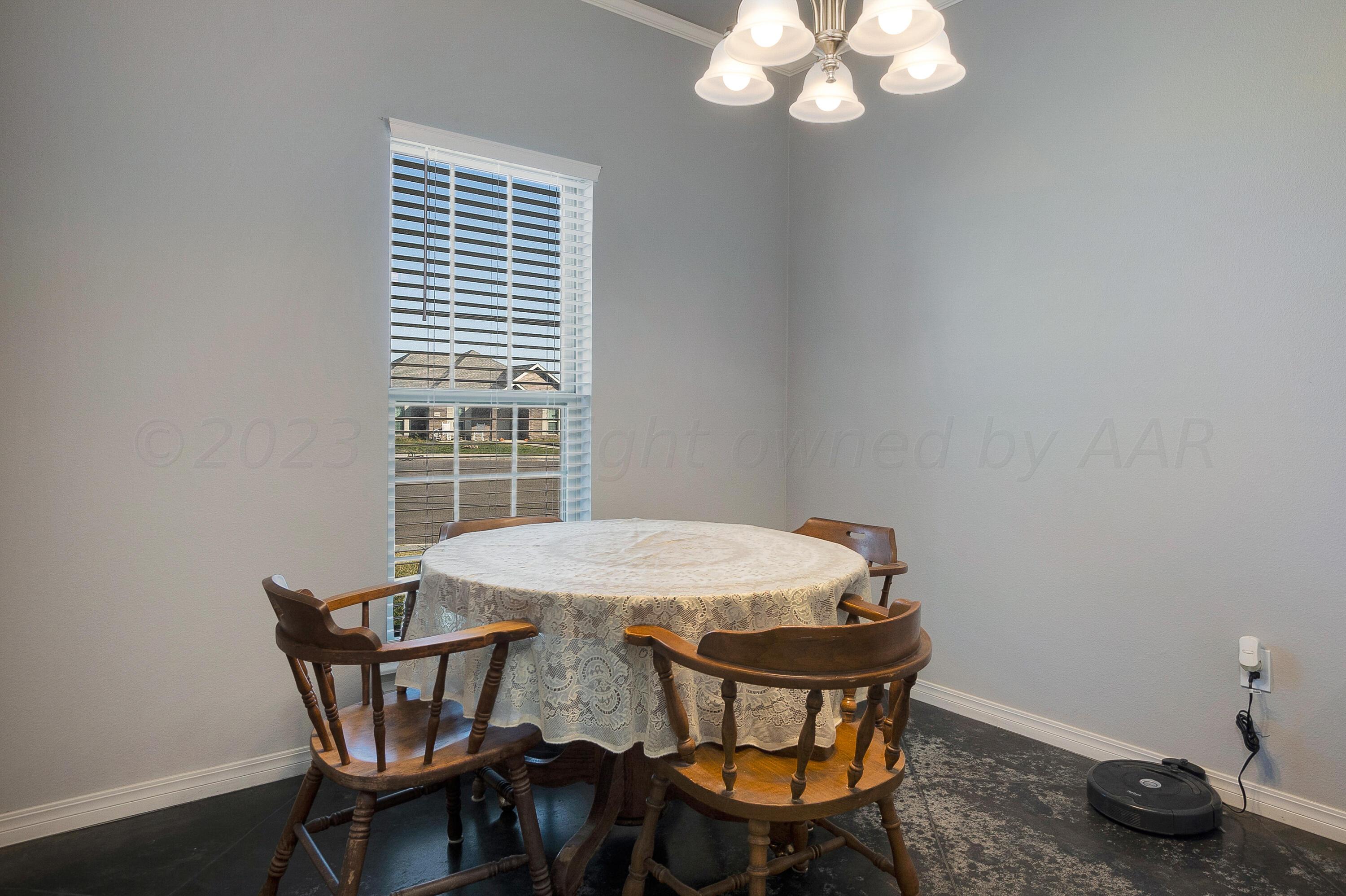 9927 Perry Avenue Amarillo, TX 79119 - Photo 11 of 24 a view of a dining room with furniture and wooden floor