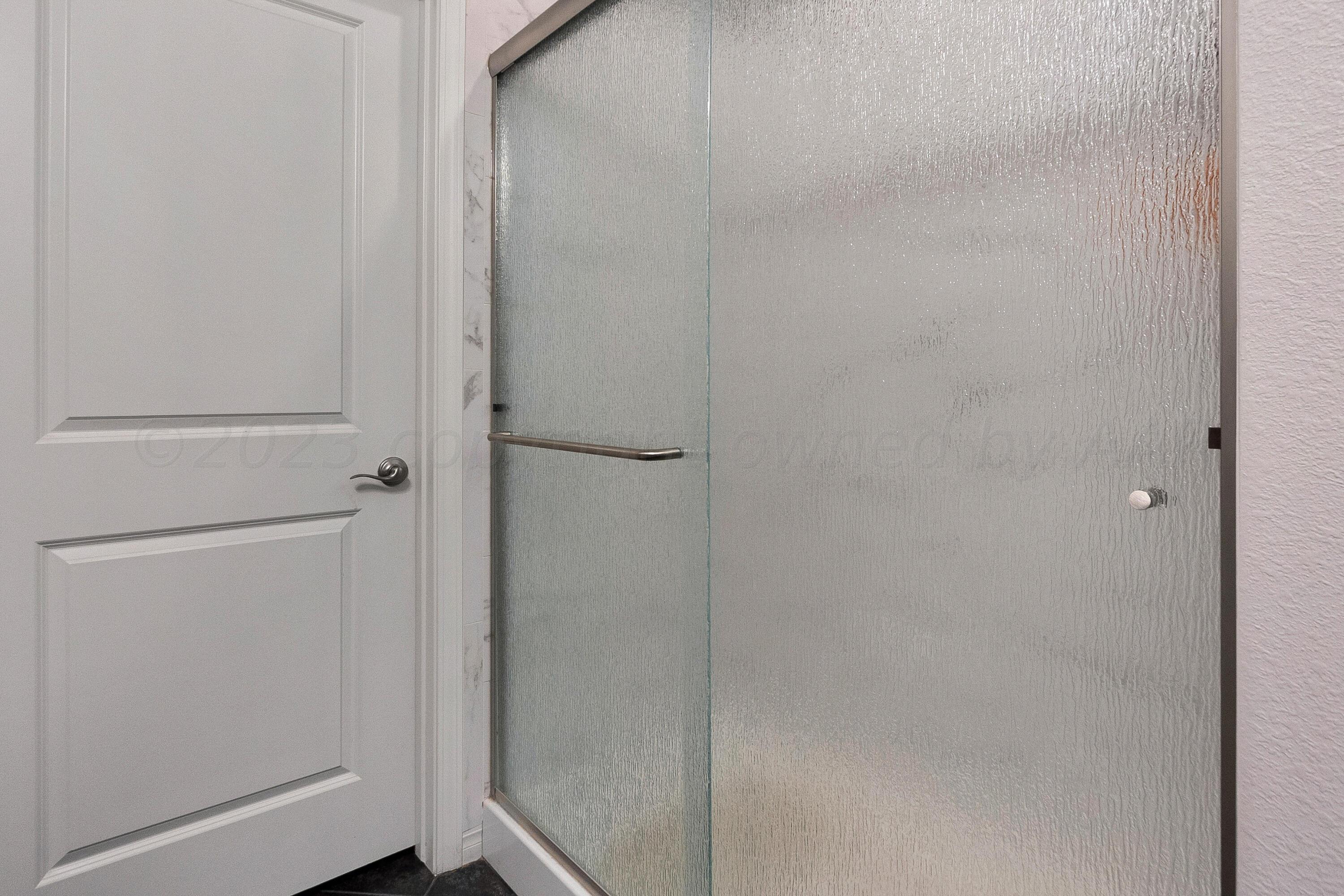 9927 Perry Avenue Amarillo, TX 79119 - Photo 15 of 24 a bathroom with a shower