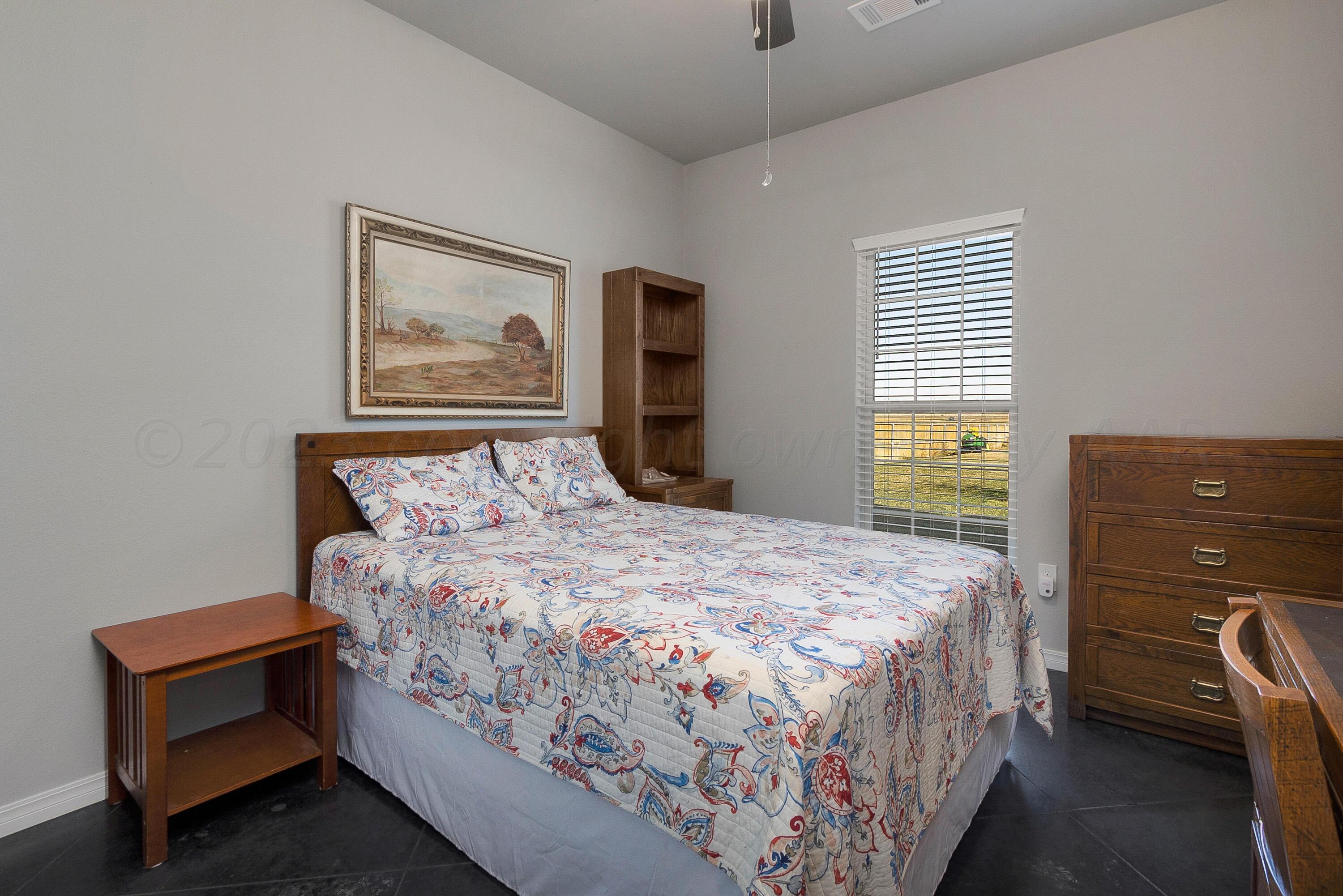 9927 Perry Avenue Amarillo, TX 79119 - Photo 16 of 24 a bedroom with a bed and a window