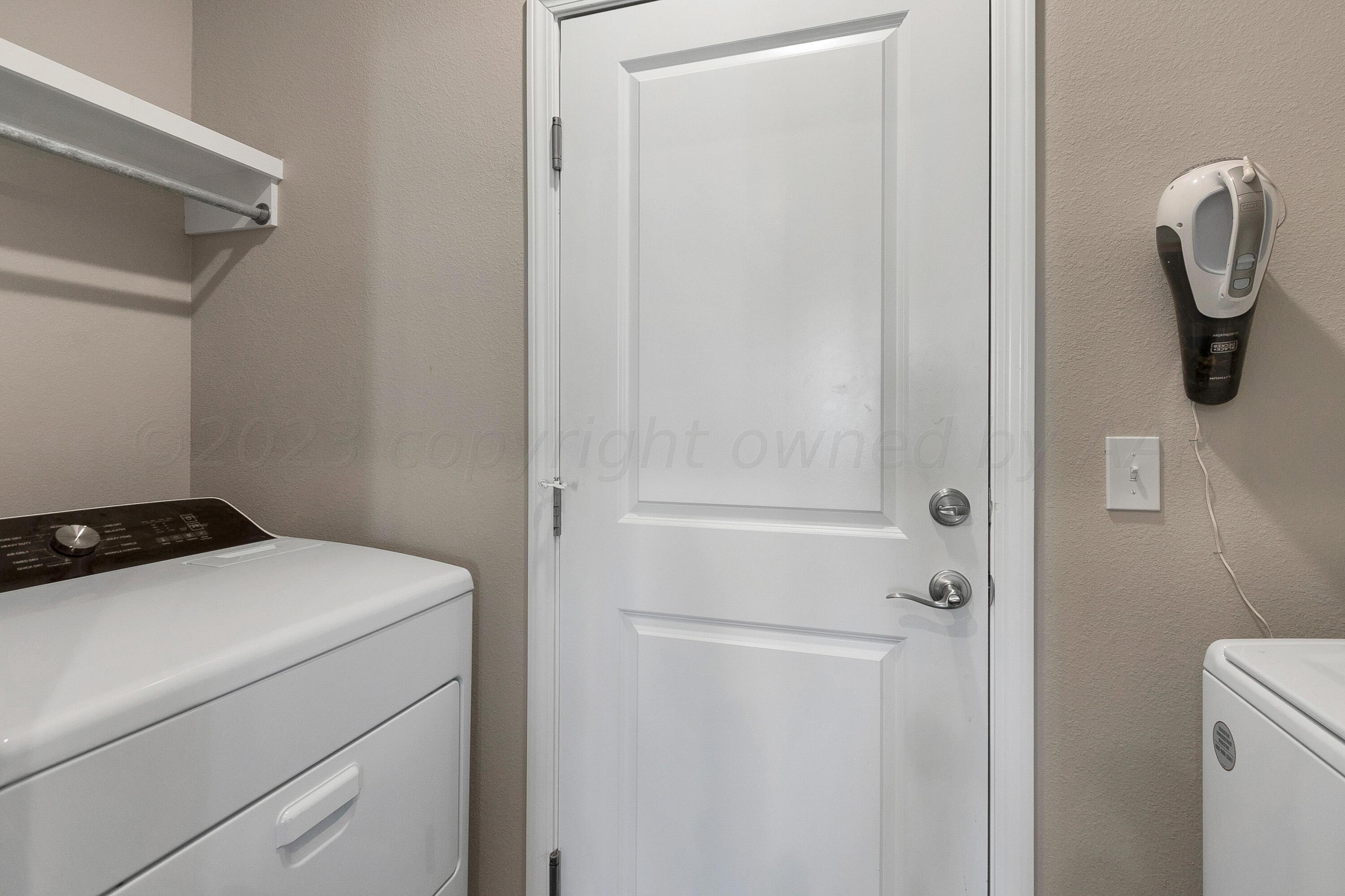 9927 Perry Avenue Amarillo, TX 79119 - Photo 19 of 24 a utility room with dryer and washer