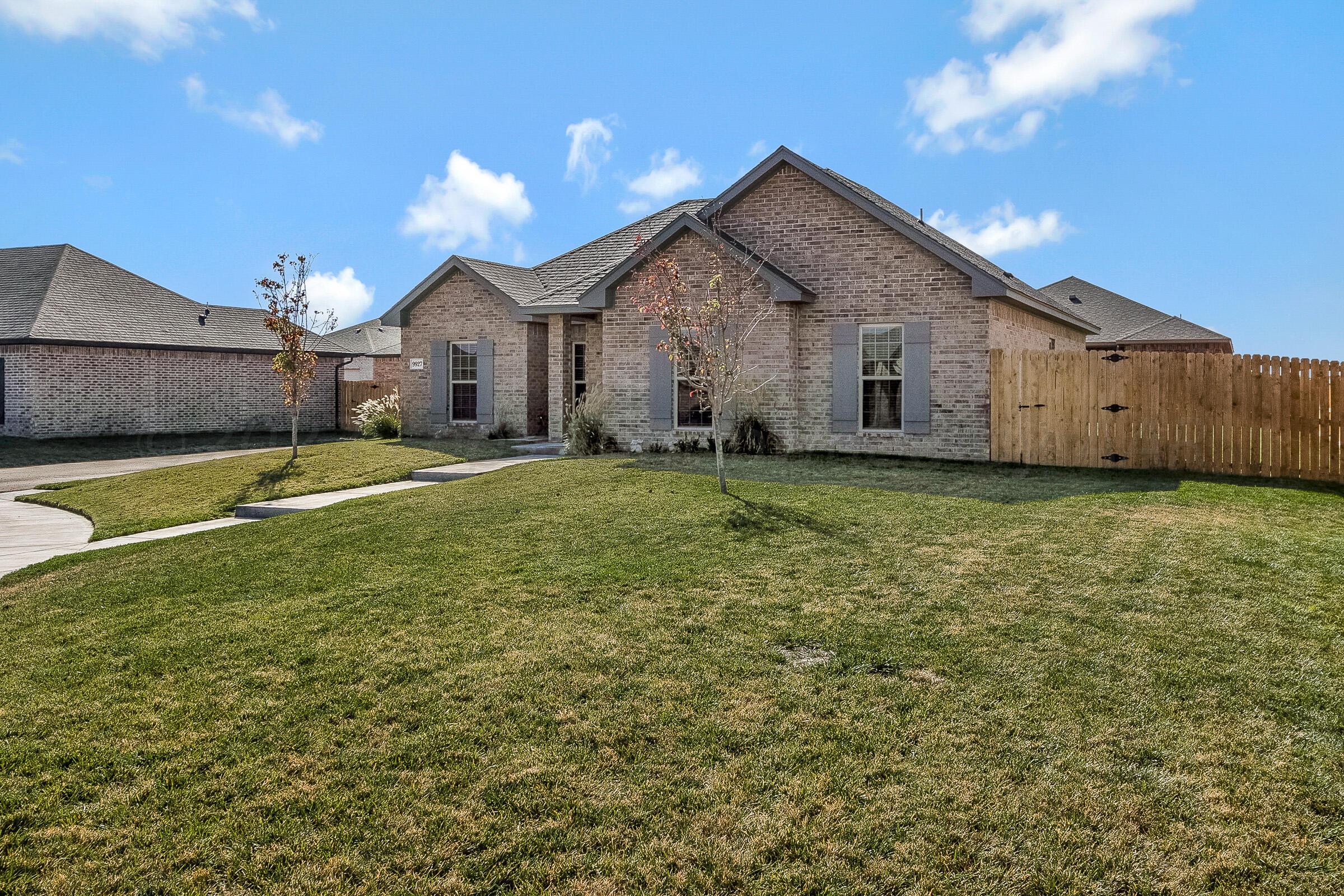 9927 Perry Avenue Amarillo, TX 79119 - Photo 2 of 24 a view of a house with a yard and garage