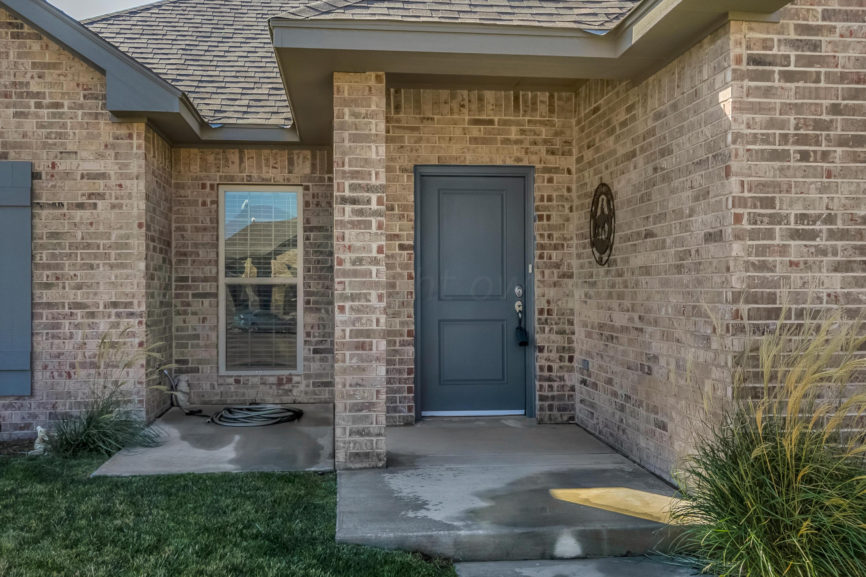 9927 Perry Avenue Amarillo, TX 79119 - Photo 3 of 24 a view of front door of a house with brick walls