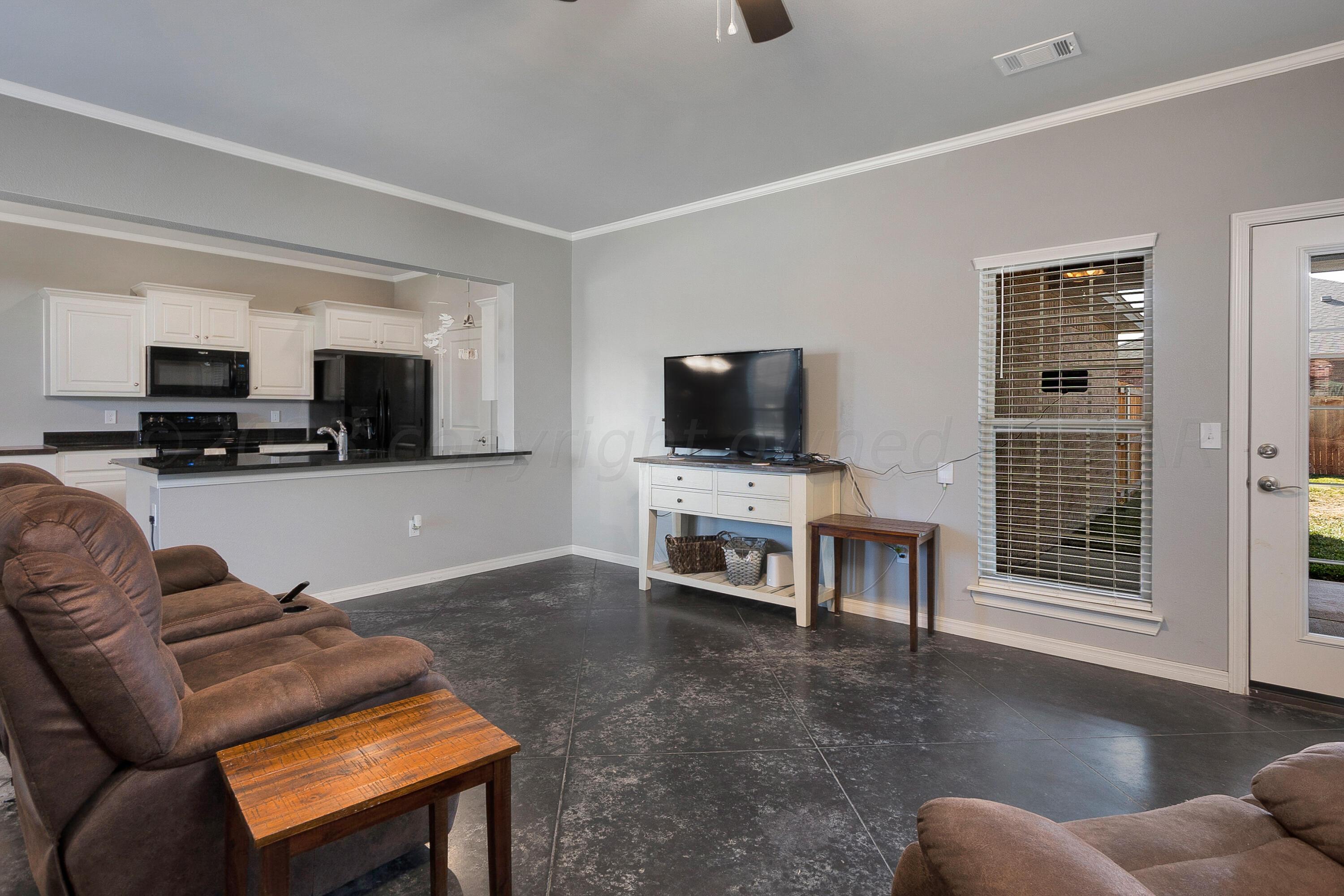 9927 Perry Avenue Amarillo, TX 79119 - Photo 5 of 24 a living room with furniture and a flat screen tv