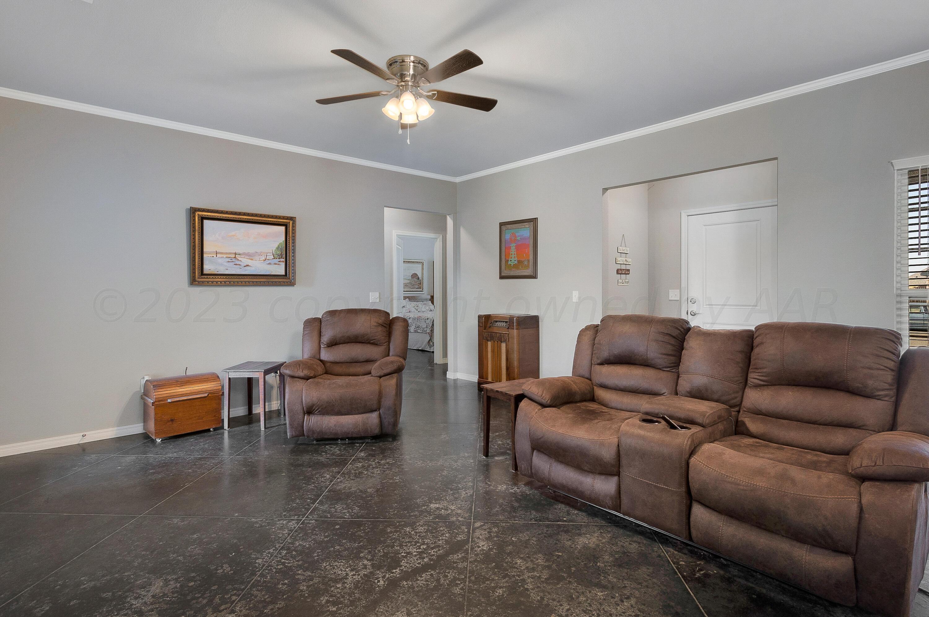 9927 Perry Avenue Amarillo, TX 79119 - Photo 6 of 24 a living room with furniture a couch and a chandelier