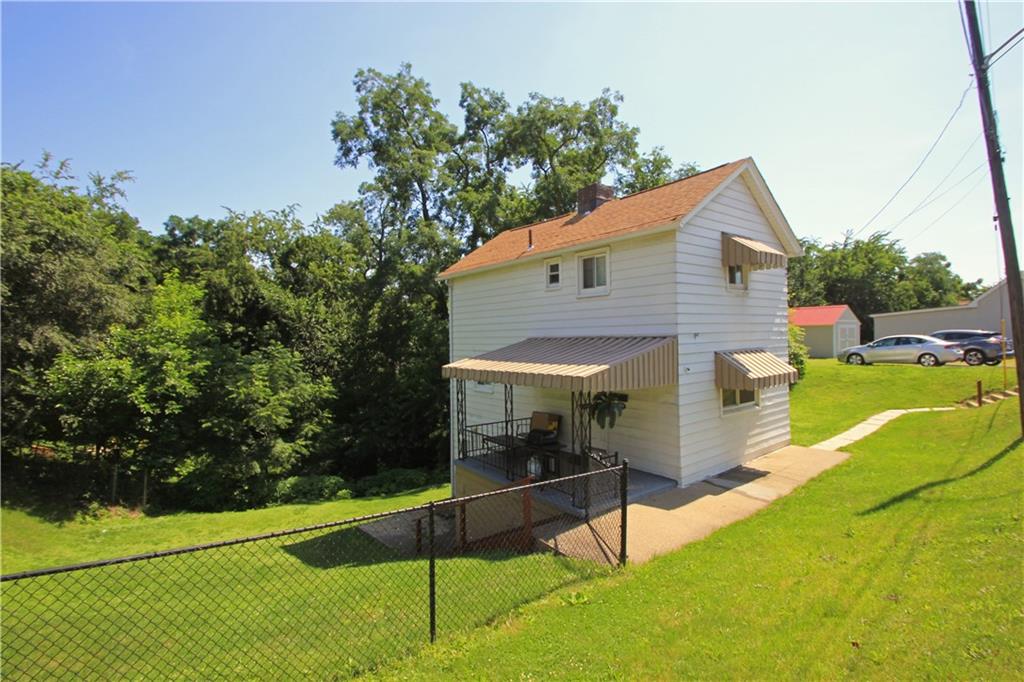 1360 Center Street McKees Rocks, PA 15136 - Photo 2 of 19 This alternate view shows the front of the house and the walkway/steps to the off-street parking.