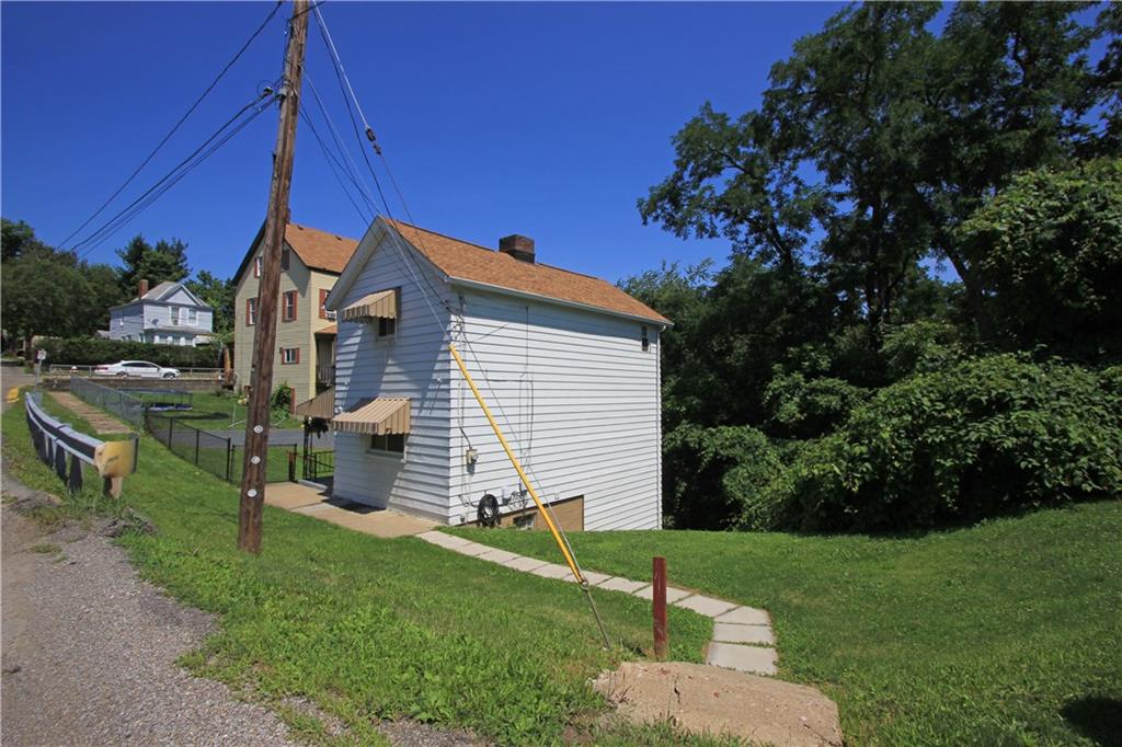 1360 Center Street McKees Rocks, PA 15136 - Photo 18 of 19 This is a view of the right side of the house which also shows the steps and walkway to the main entry door.