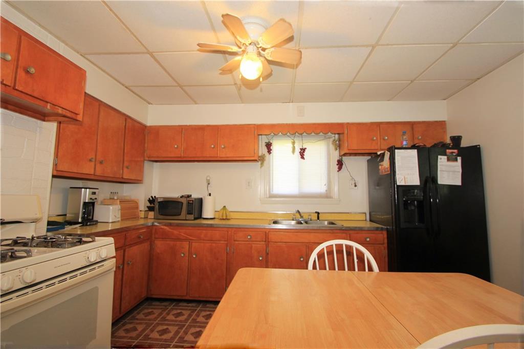 1360 Center Street McKees Rocks, PA 15136 - Photo 5 of 19 The kitchen has plenty of wood cabinetry and spacious counter top area. The window looks out over the side yard.