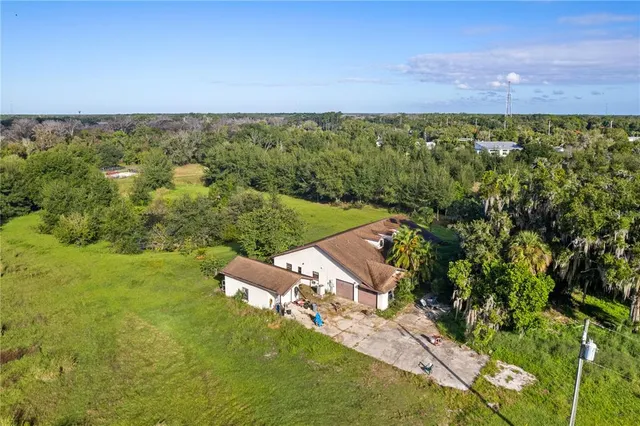 an aerial view of a house with a yard
