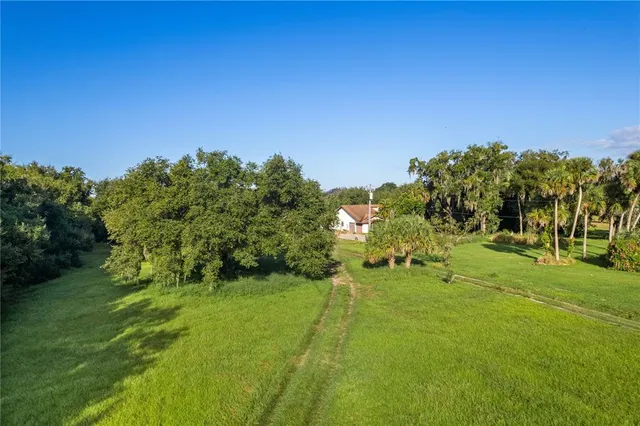 a backyard of a house with a yard and outdoor seating