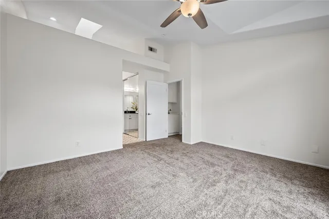 a bathroom with a granite countertop sink a toilet and shower