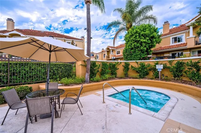 a view of a swimming pool with a lounge chair and tables