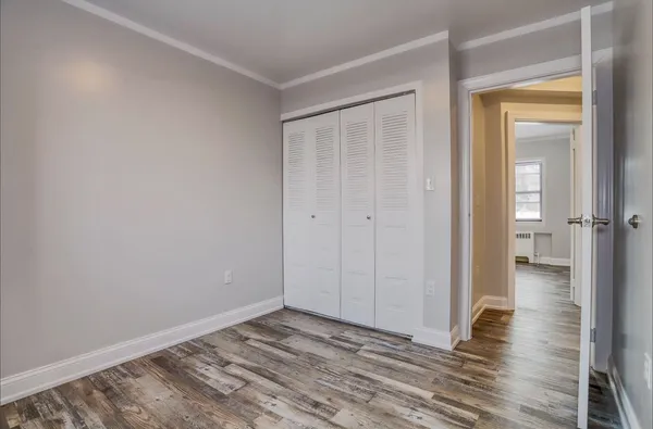 a view of a room with wooden floor and closet