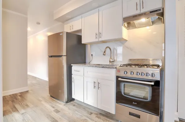a kitchen with a stove and a refrigerator