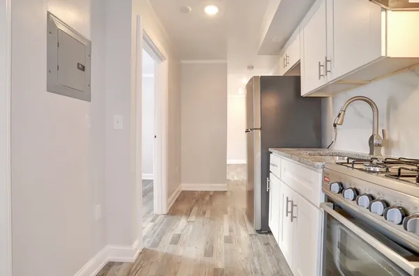 a kitchen with a stove and a refrigerator