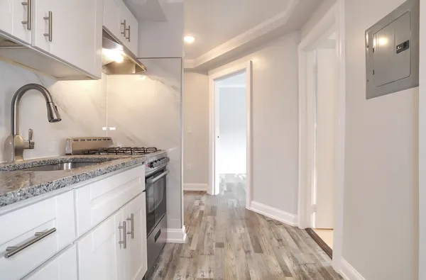 a view of a sink and dishwasher with wooden floor