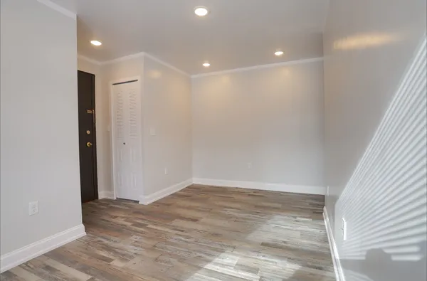 a view of hallway with wooden floor