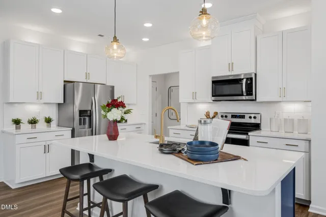 a bedroom with a bed a mirror and lamp