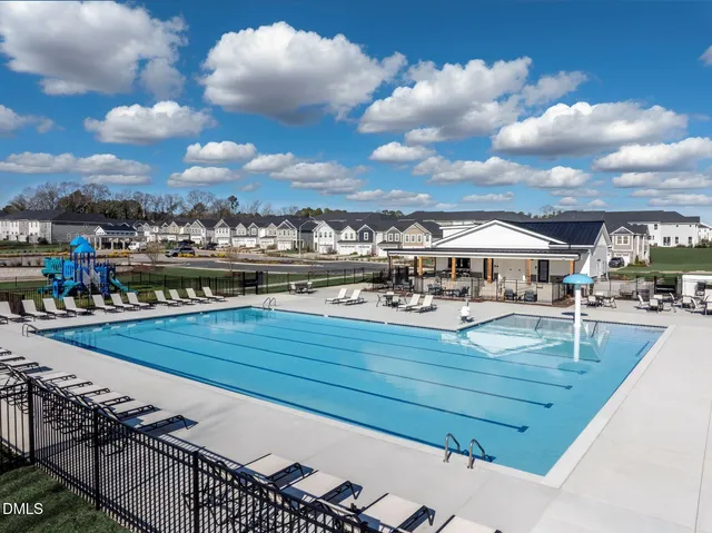 a view of a swimming pool and outdoor seating