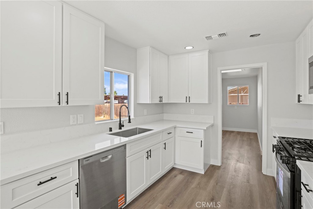 1116 7th Street Calimesa, CA 92320 - Photo 11 of 52 a kitchen with a sink cabinets and wooden floor