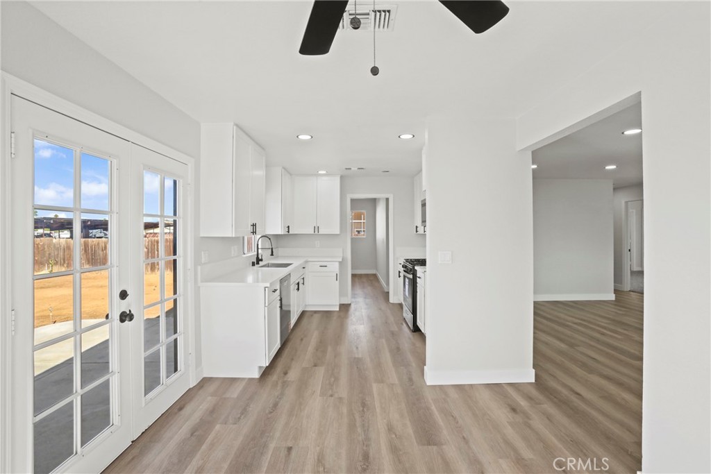 1116 7th Street Calimesa, CA 92320 - Photo 12 of 52 a view of a kitchen with kitchen island wooden floor center island and stainless steel appliances
